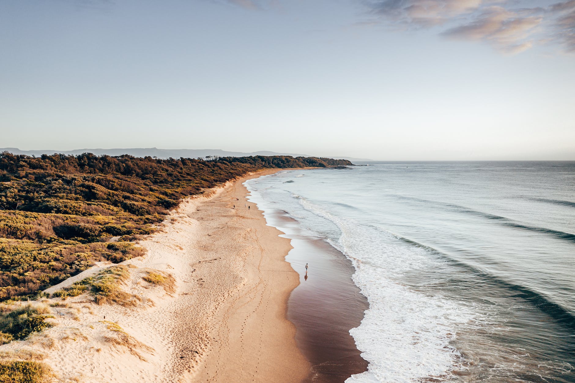 rocky coast with sandy beach and wavy sea